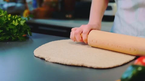 Rolling out the dough on the table using the dough trolley Stock-Footage 249080127