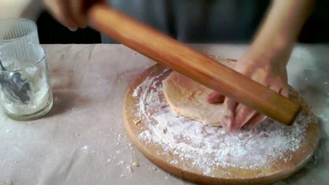 Rolling out orange dough Stock Footage 83107719