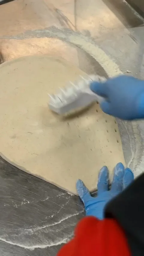 Rolling out pizza dough. Stock Footage 310943026