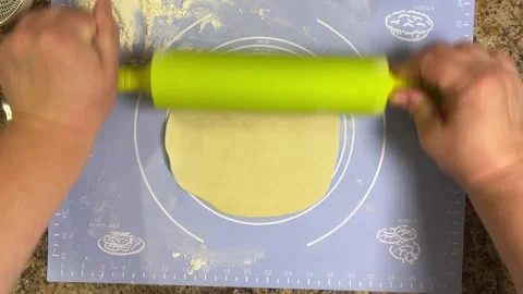 Rolling out round pieces of raw dough with a rolling pin to make patties. Top vi Stock Footage 300457199