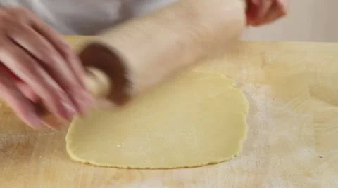 Rolling out shortbread dough with a rolling pin Stock Footage 24663239