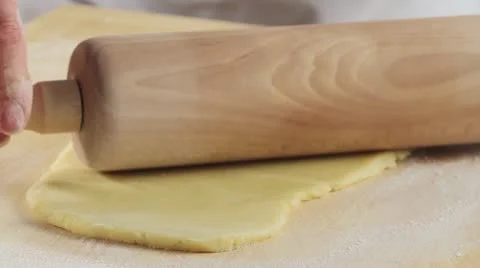 Rolling out shortbread dough with a rolling pin Stock Footage 24663255