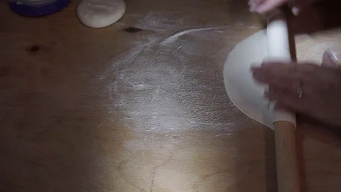 Rolling out stiff dough Stock Footage 106197621