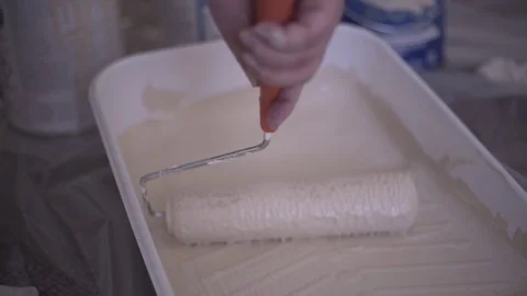Rolling Paint Roller In Light Brown Paint While Painting Room Stock Footage 88013782