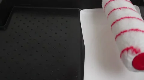 Rolling paint roller in white paint in a tray Stock-Footage 43970142