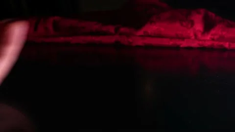 Rolling a pair of dice on black table in front of a red blanket. Vidéo 201199056