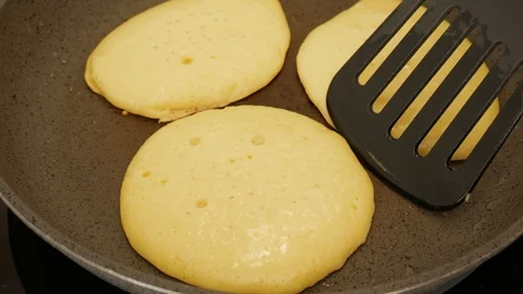 Rolling pancakes on the pan 스톡 동영상 124673898