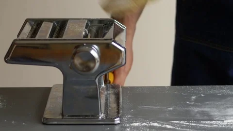Rolling pasta dough with a pasta machine Stock Footage 71237496