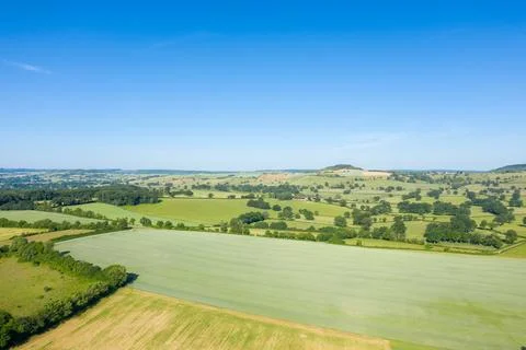 Rolling patchwork fields under clear sky, Nivernais 스톡 사진
