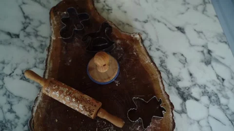 A rolling pin and cookie cutters are on the table in the Christmas kitche Stock Footage 296045920