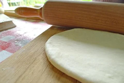 Rolling pin and dough to make bread 스톡 사진