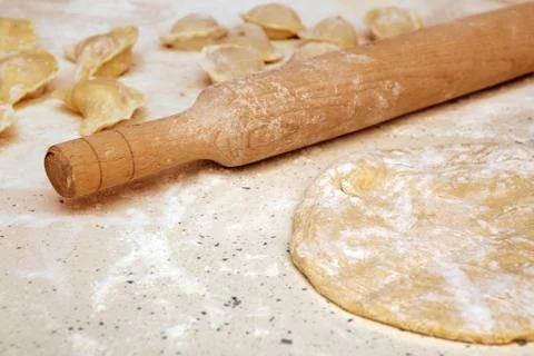 Rolling pin and dough on table Stock Photos