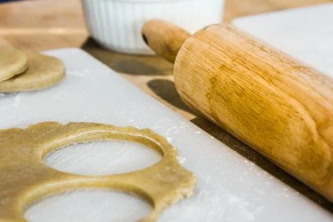 Rolling pin and dough on a table Stock Photos