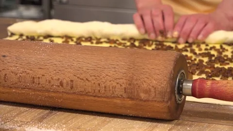 Rolling Pin and Raisin Bun being prepared Stock Footage 239694114