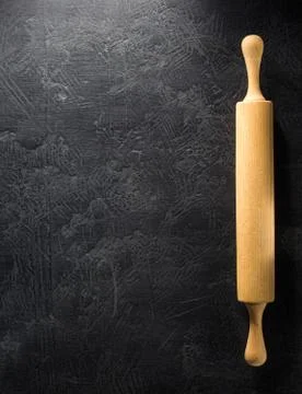 Rolling pin at black Stock Photos