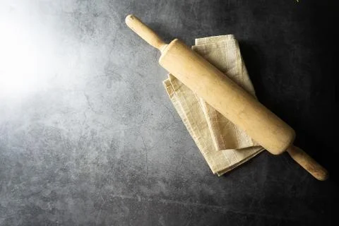 Rolling pin on dark floor Stock Photos