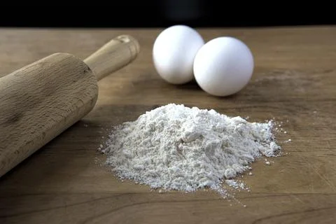 Rolling pin, eggs, and flour. Stock Photos