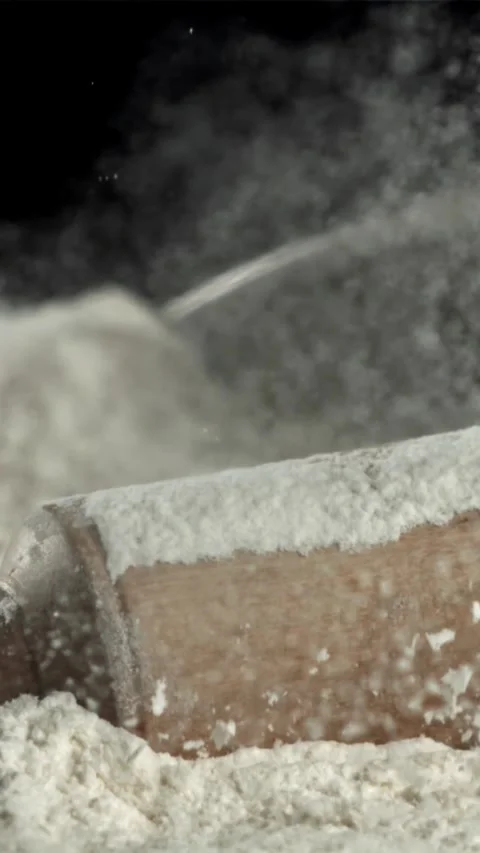 The rolling pin falls into the flour. Filmed on a high-speed camera at 1000 fps Stock Footage 335361069