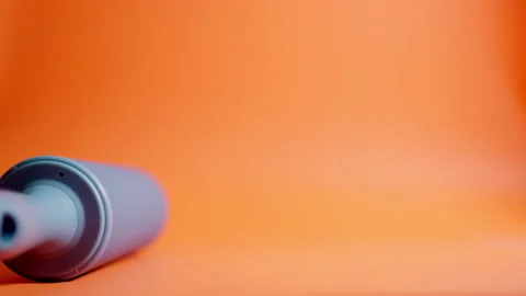 Rolling pin rolls from left to right. Orange background. Stock Footage 144416566