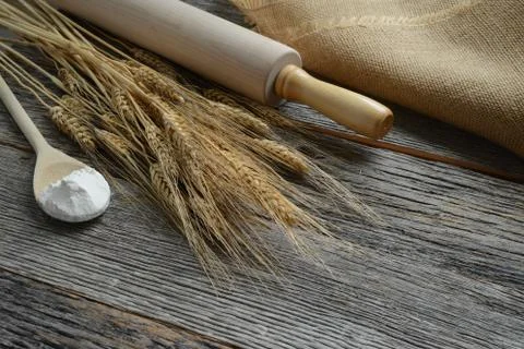 Rolling pin with wheat and spoon with flour Stock Photos