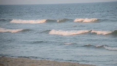 Rolling pink ocean waves at beach during sunset Video stock 94821412