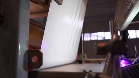 Rolling plastic foil sheet on automated machine tool in shop Stock Footage 304390236