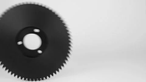 Rolling plastic gears in black, isolated on a white background. Stock Footage 111534891