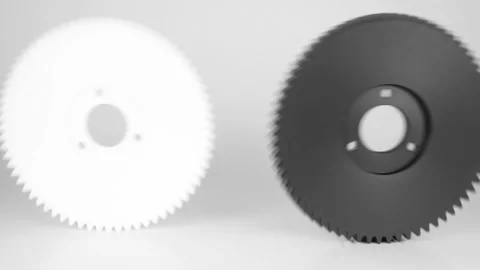 Rolling plastic gears in white and black, isolated on a white background. Stock Footage 111534944