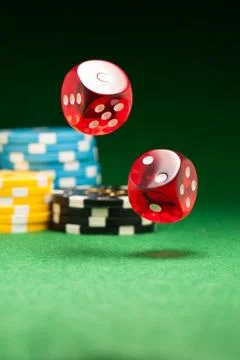 Rolling red dice Stock Photos
