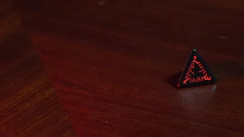 Rolling red four sided dice Stock Footage 198946830