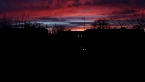 Rolling red purple sunset cloud time lapse above residential apartment Stock Footage 235765084