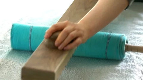 Rolling in a roll of wool felt using Rubel. Front view. Stock Footage 88959183