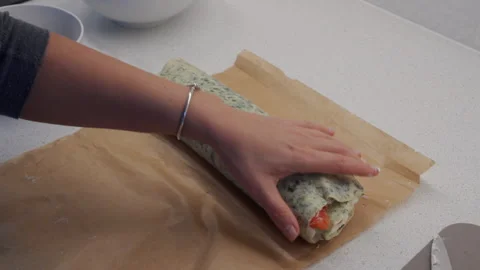 Rolling saj bread with whipped cheese and salmon into log shape. 動画素材 295281782