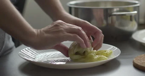 Rolling sarma rolls in cabbage leaf 5.7K footage Stock Footage 303341730