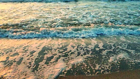 Rolling sea waves with white foam on the sandy beach of the seashore Stock Footage 302971565