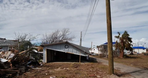 Rolling by several severely damaged or destroyed houses in Mexico Beach Stock Footage 98788602