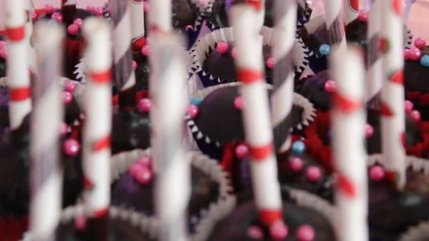 Rolling shoot on table Cupcake on a bunch with chocolate coated cake Stock Footage 146202878
