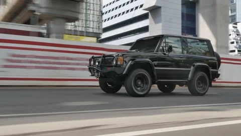ROLLING SHOT A 4X4 CAR IN THE MIDDLE OF JAKARTA Stock Footage 286086019