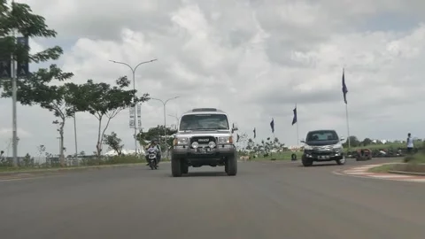 ROLLING SHOT 4X4 OLD CAR IN THE ROAD OF JAKARTA Stock Footage 286079472