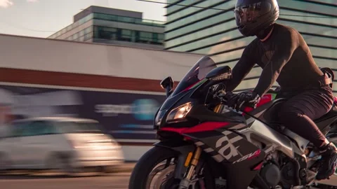 Rolling shot of man biker riding Aprilia RSV4 motorcycle in the city street Stock Footage 214079105