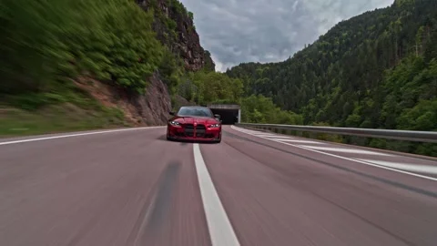 Rolling shot of red BMW M3  speeding on a highway road Stock Footage 328647849