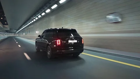 Rolling shot of Rolls Roys Cullinan car driving in the tunnel at night in Dubai Stock Footage 200033770