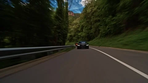 Rolling shot of two Bmw m4 sports cars driving on a road Stock Footage 328648011