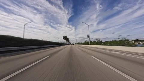 Rolling shot of white SUV pickup truck driving on the highway in Miami Florida Stock Footage 276654388