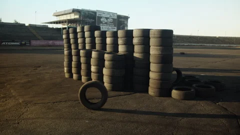 Rolling of single tire in racing stadium Stock Footage 248183261