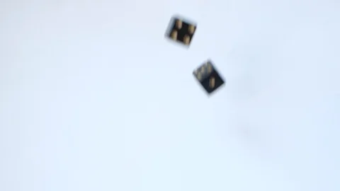 Rolling a six and a five with a pair of black gambling dice on a table in slow Stock Footage 109138942