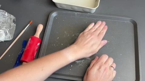 Rolling soft clay by hand into a coil for a miniature pumpkin craft Stock Footage 345720196