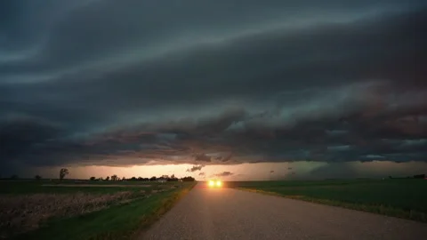 Rolling storm clouds moving across powerful sky dramatic 4K timelapse Video stock 338173445