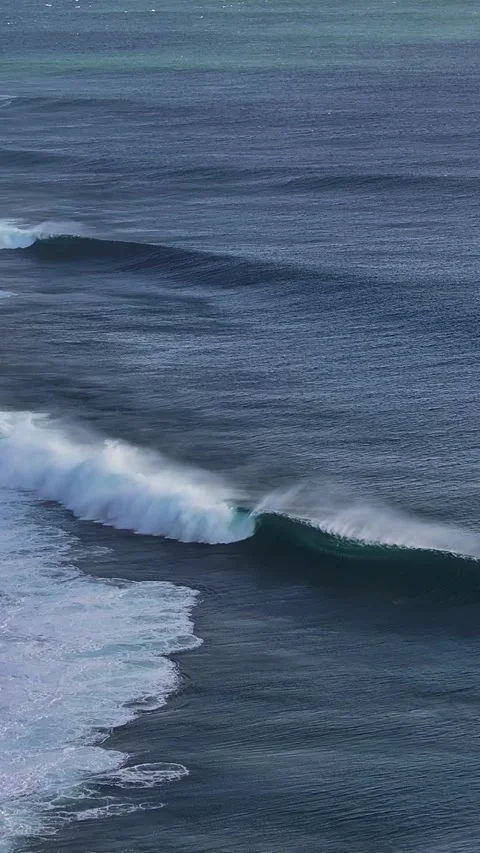 Rolling Surf Waves Under Clear Skies Along a Remote Coastline Stock Footage 335197793