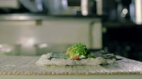 Rolling up the sushi roll with bamboo mat, close up view Stock Footage 41948651
